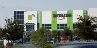 Cars pass by the Amazon distribution warehouse in the industrial area of Fontana, California in the Inland Empire where Secondary Market Rents Soar