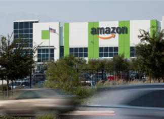 Cars pass by the Amazon distribution warehouse in the industrial area of Fontana, California in the Inland Empire where Secondary Market Rents Soar