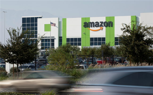 Cars pass by the Amazon distribution warehouse in the industrial area of Fontana, California in the Inland Empire where Secondary Market Rents Soar